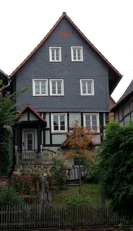 a black house with a fence in front of it at Fachwerkhaus in Wolfhagen