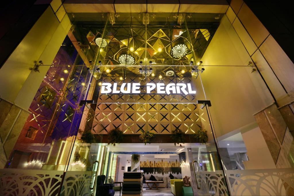 a restaurant with a blue pearl sign on the facade at Hotel Blue Pearl in New Delhi
