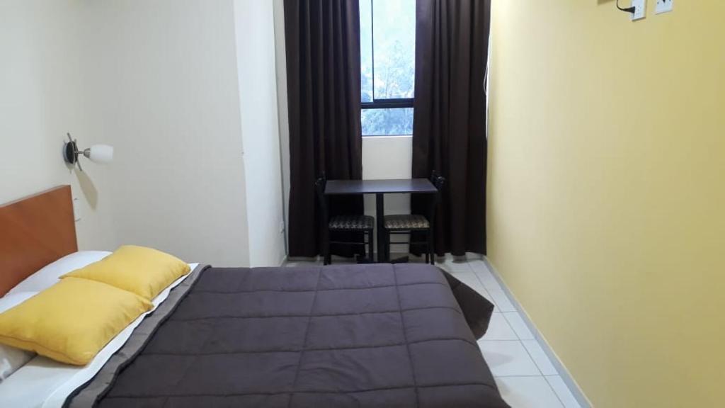 A bed or beds in a room at Hostal Tambo Alto