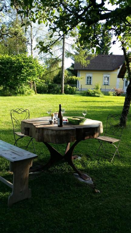 a picnic table with a bottle of wine sitting on it at Appartements Maximilian in Göstling an der Ybbs