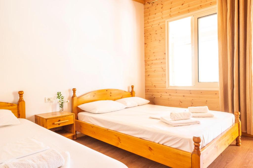 a bedroom with two beds and a window at Nashos Bungalows in (( Spile ))