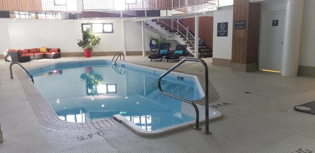 a large swimming pool in a large building at Super 8 by Wyndham Spruce Grove in Spruce Grove