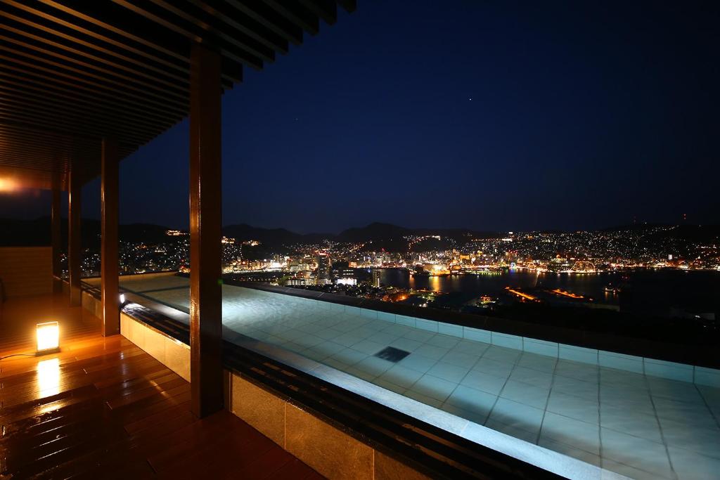 a view of a city at night from a building at Ooedo Onsen Monogatari Nagasaki Hotel Seifu in Nagasaki