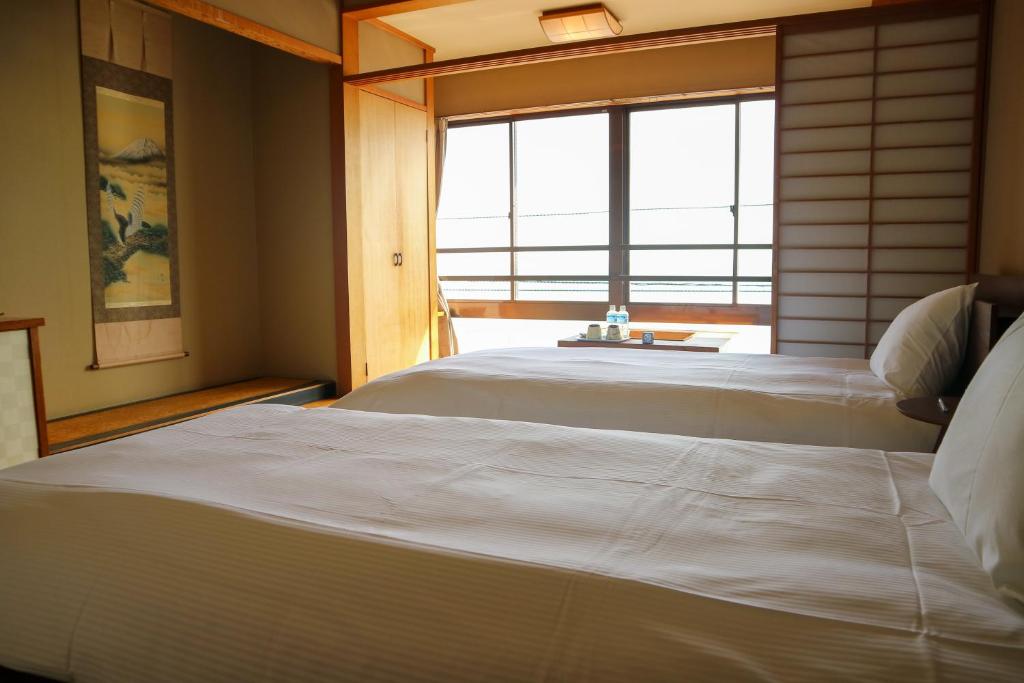 Postel nebo postele na pokoji v ubytování HOTEL&RESORT Izu no Ne