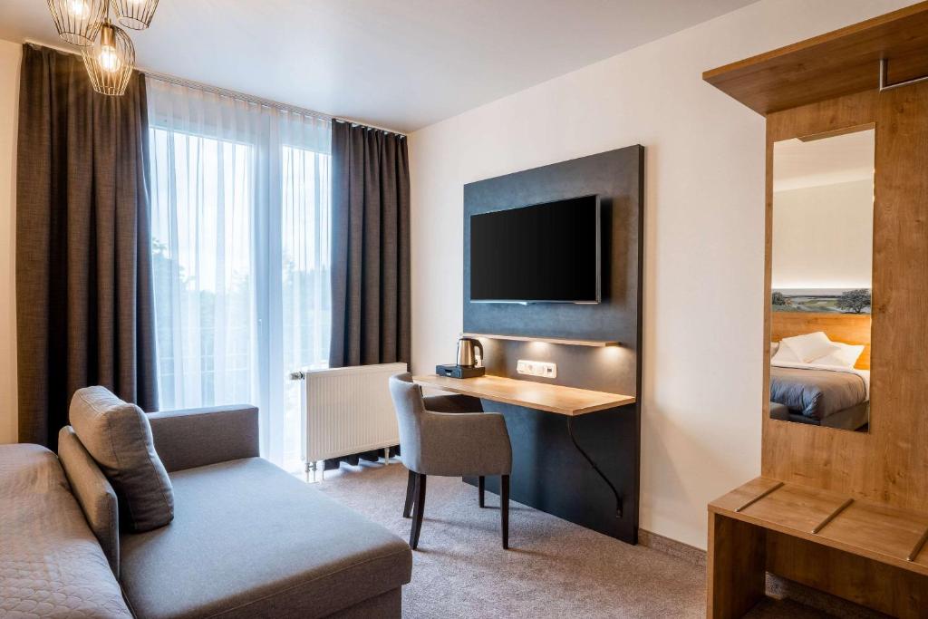 TV a/nebo společenská místnost v ubytování MEAT UND STAY Hotel