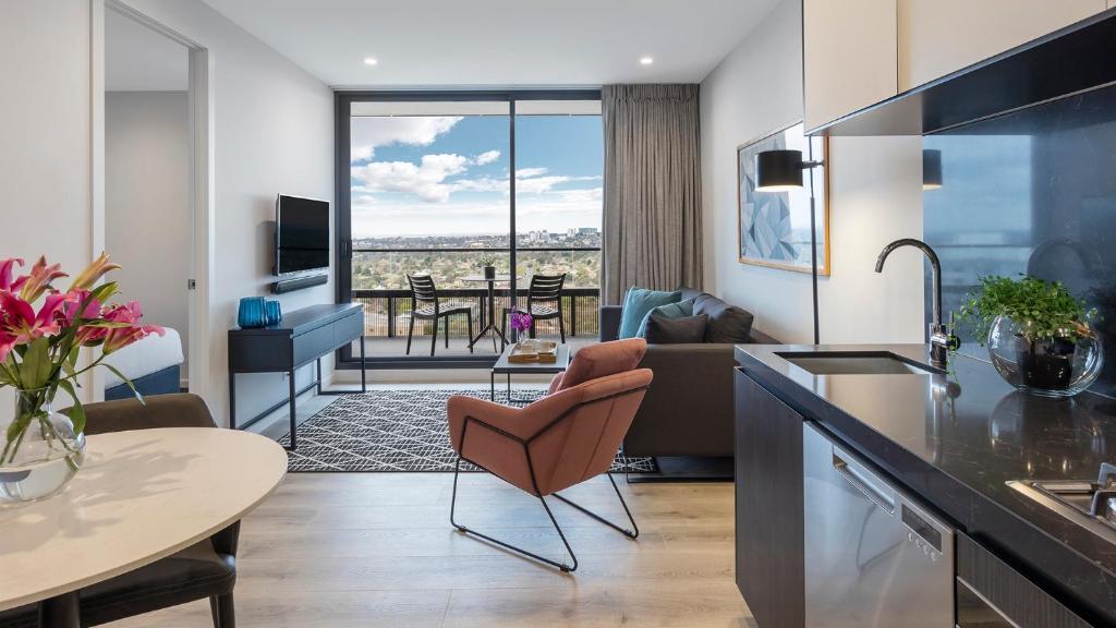 a kitchen and living room with a view of a room at Avani Melbourne Box Hill Residences in Box Hill