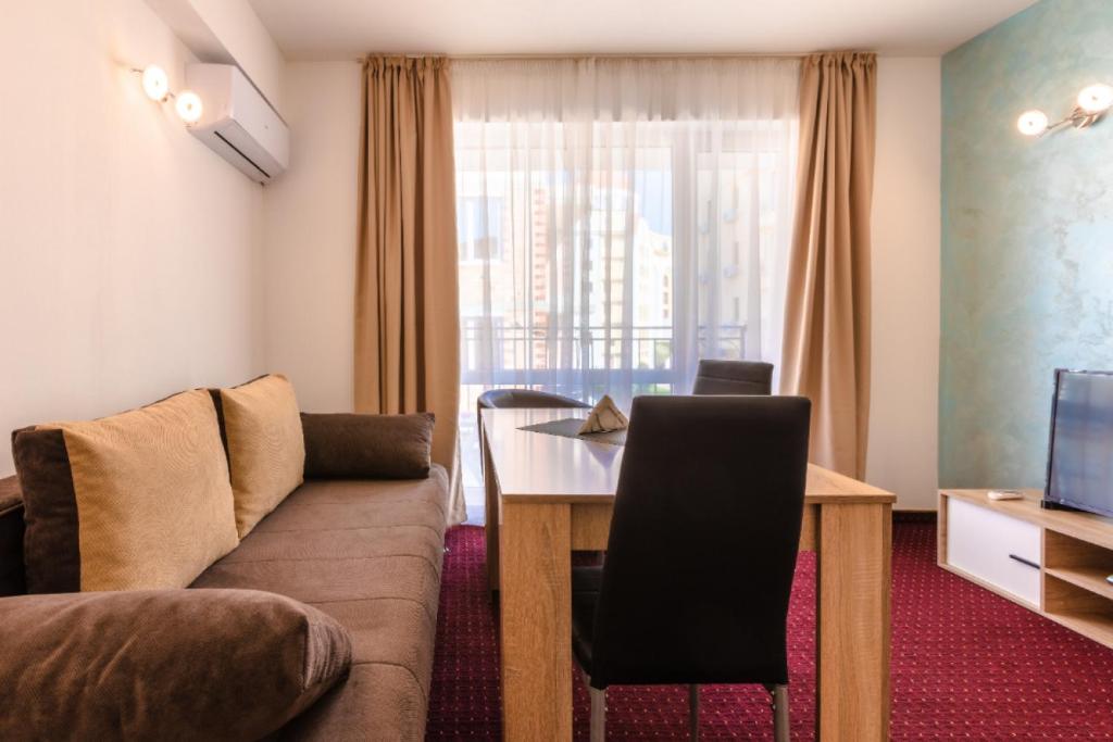 a living room with a couch and a table at Guest House Theona in Obzor
