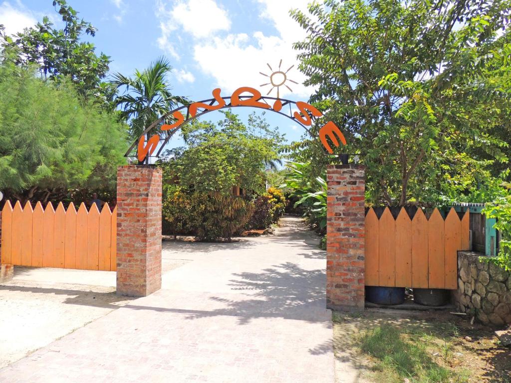 an entrance to a driveway with an orange gate at Sunrise Club Hotel in Negril