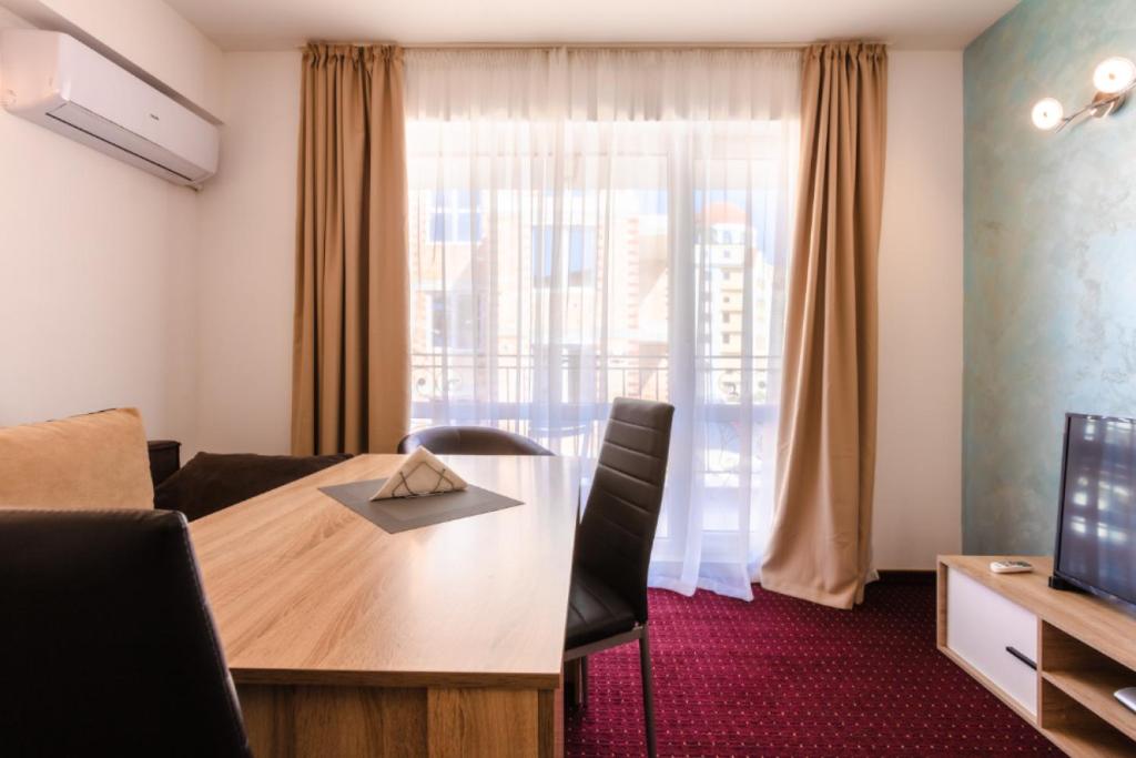 a room with a table and a large window at Guest House Theona in Obzor
