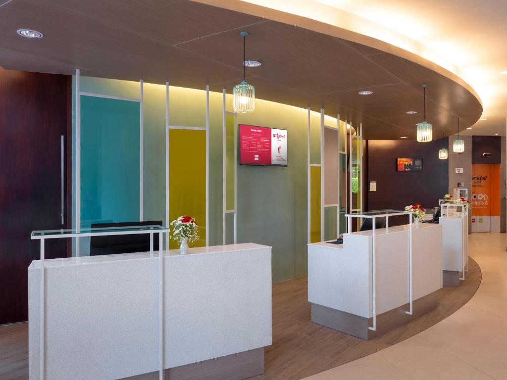 a lobby with a reception desk in a building at Ibis Phuket Patong in Patong Beach