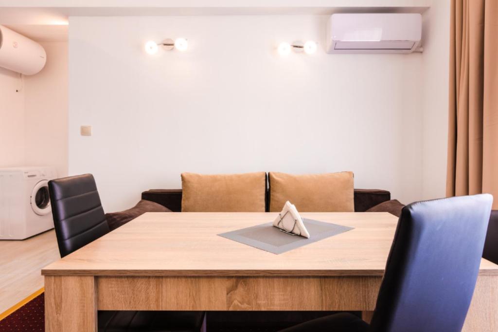 a dining room table with two chairs and a table at Guest House Theona in Obzor
