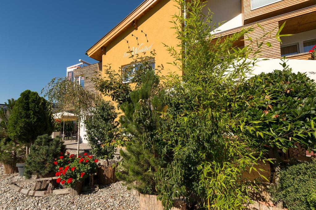 a house with plants and flowers in front of it at Der Winklhof in Saalfelden am Steinernen Meer