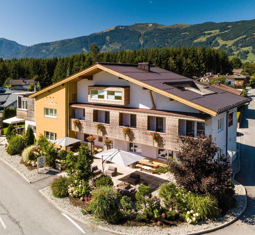 an aerial view of a house with mountains in the background at Der Winklhof in Saalfelden am Steinernen Meer