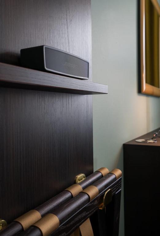 a shelf with a cell phone sitting on top at Thon Hotel Brønnøysund in Brønnøysund