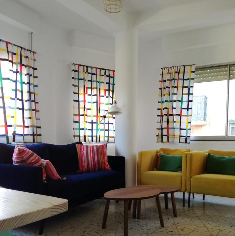 a living room with two couches and stained glass windows at Casa Oroela in Jaca
