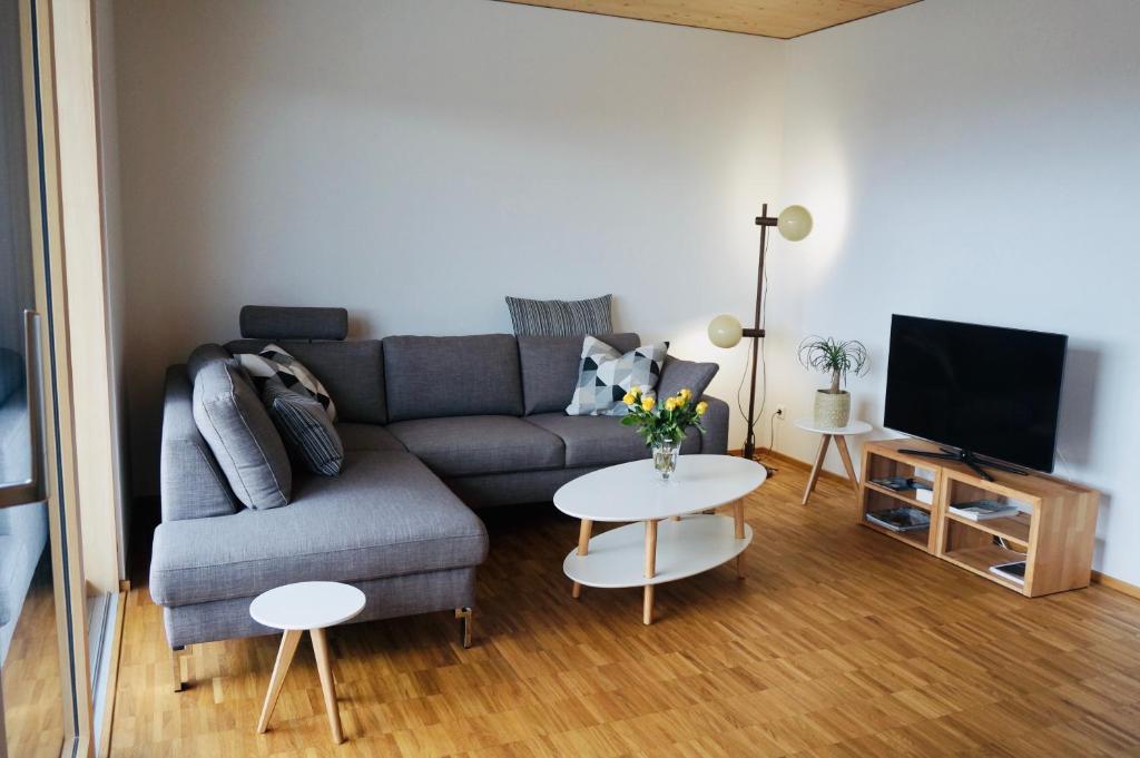 a living room with a couch and a table at Hengnau 46, Ferienwohnung Stiefel in Wasserburg am Bodensee