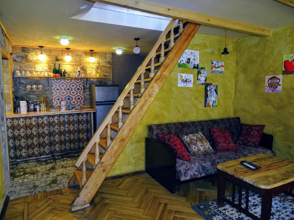a living room with a staircase and a couch at Paparti in Tbilisi City