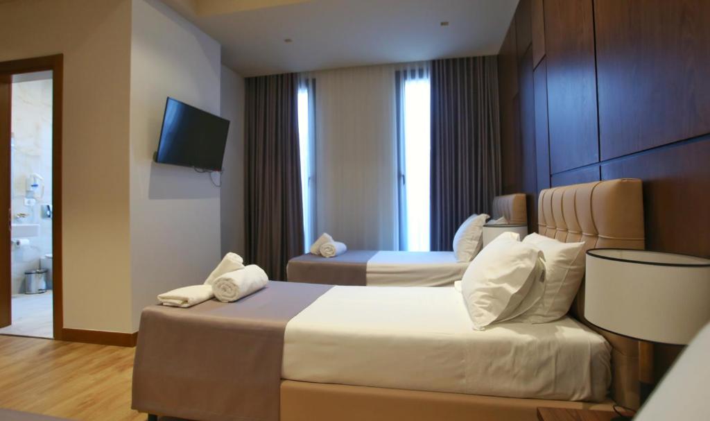 Uma cama ou camas num quarto em Portik Hotel