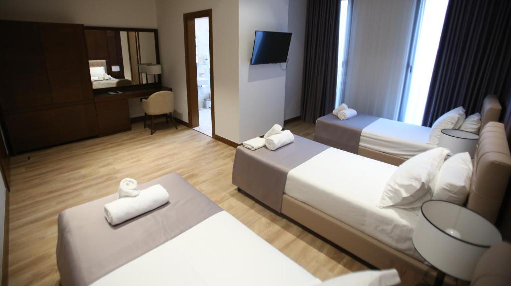 Uma cama ou camas num quarto em Portik Hotel