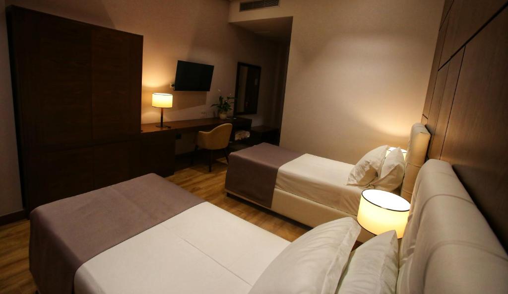 Uma cama ou camas num quarto em Portik Hotel