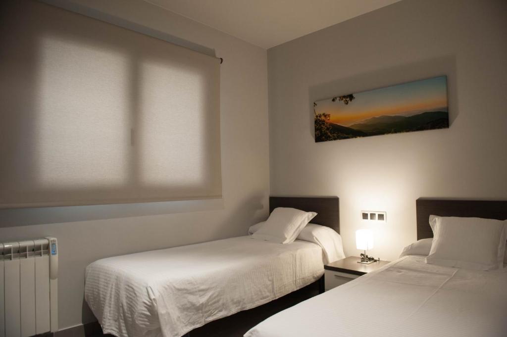 Postel nebo postele na pokoji v ubytování WinTuWin Apartments