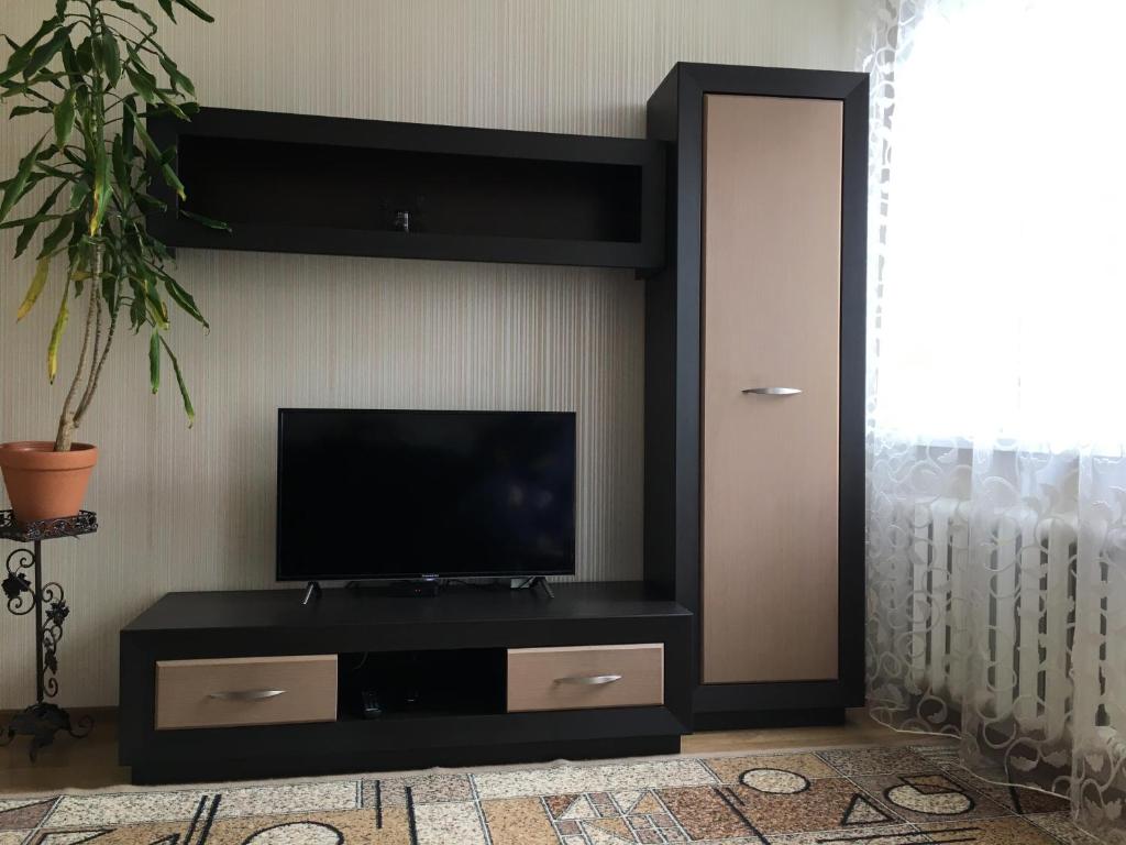 a black entertainment center with a flat screen tv at Великолепное расположение! Центр ! in Brest