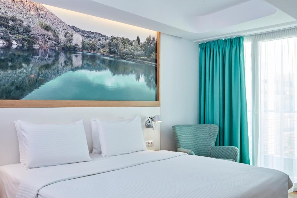 Postel nebo postele na pokoji v ubytování Olive Green Hotel
