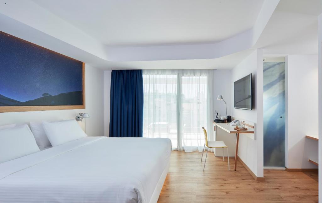 Postel nebo postele na pokoji v ubytování Olive Green Hotel