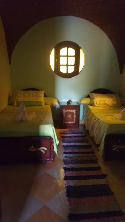Postel nebo postele na pokoji v ubytování Kindaka amany