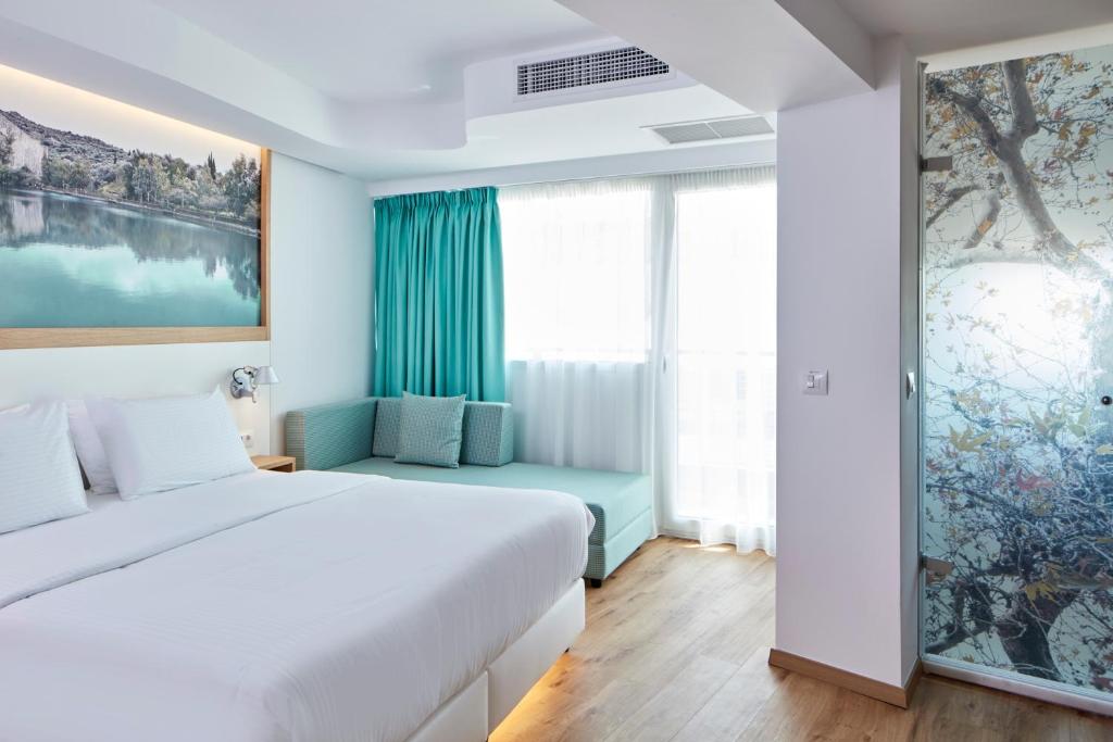 Postel nebo postele na pokoji v ubytování Olive Green Hotel