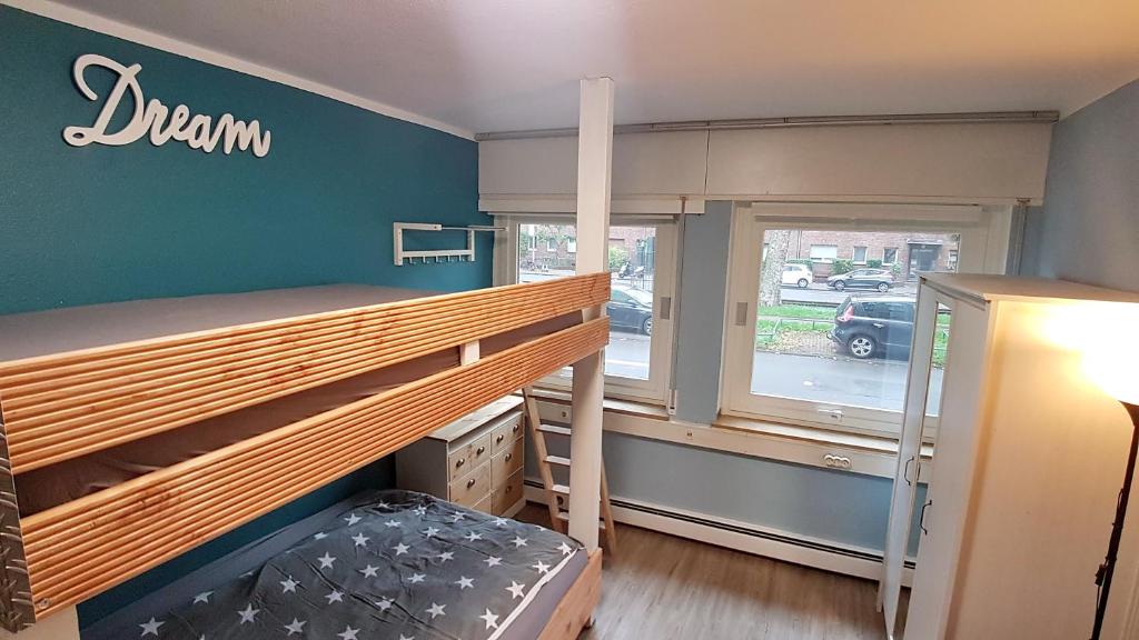 a bedroom with a bunk bed and a window at Apartment Weinsberg in Cologne