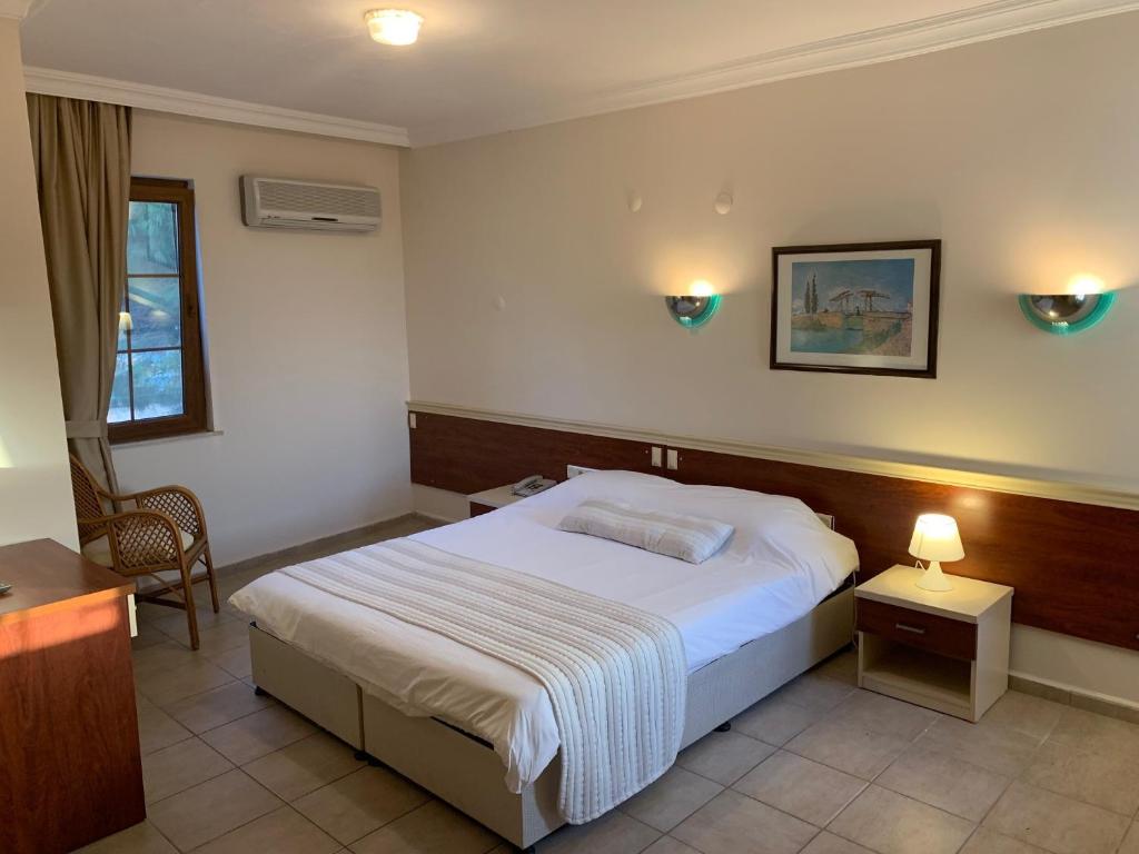 A bed or beds in a room at Olympos Hotel - Adults Only