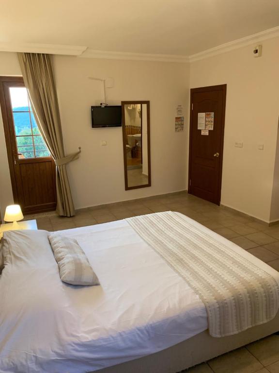 A bed or beds in a room at Olympos Hotel - Adults Only