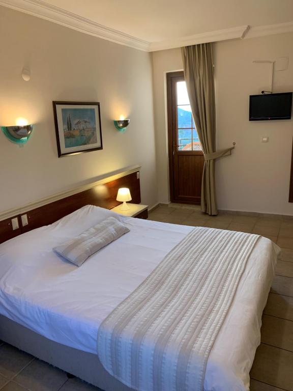 A bed or beds in a room at Olympos Hotel - Adults Only