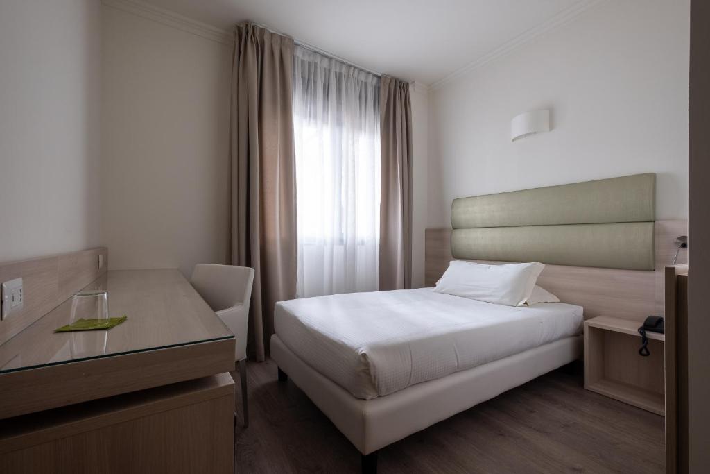 Postel nebo postele na pokoji v ubytování Hotel La Torretta