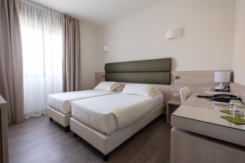 Postel nebo postele na pokoji v ubytování Hotel La Torretta
