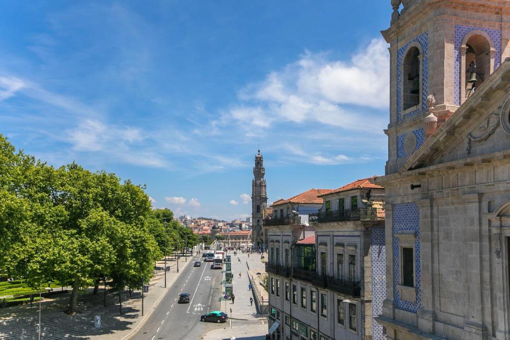 a view of a city street with a clock tower at Casa da Cordoaria in Porto