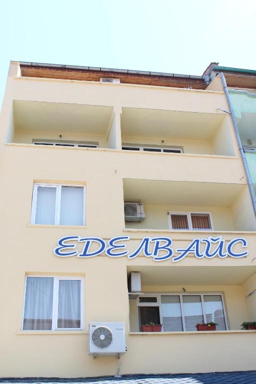 a sign on the side of a building at Edelvais Guest House in Primorsko