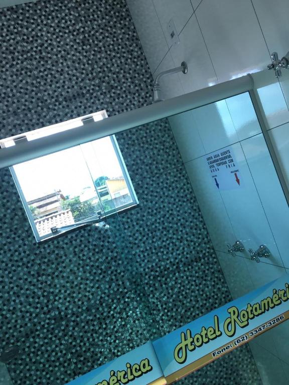 a glass floor in a building with a sign in it at Hotel Rotamerica in Campinorte