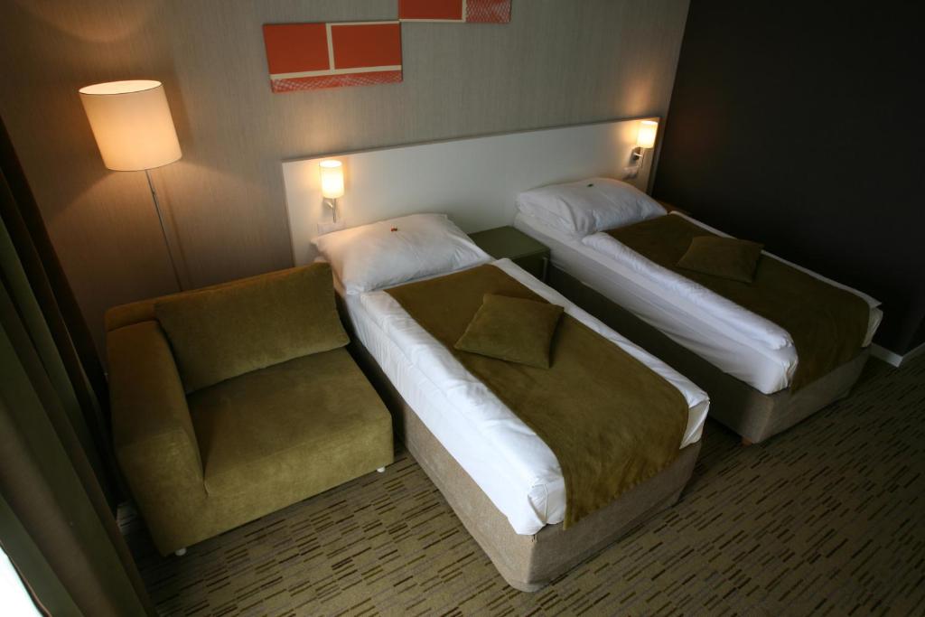 Postel nebo postele na pokoji v ubytování Hotel EMPIRE