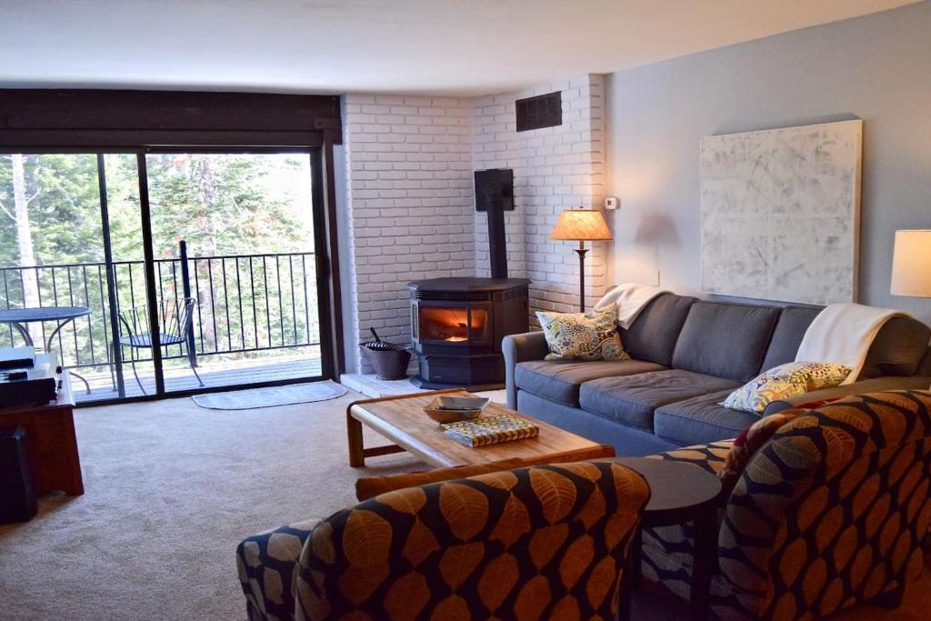 a living room with a couch and a wood stove at Chez Vaupen in Alpine Meadows