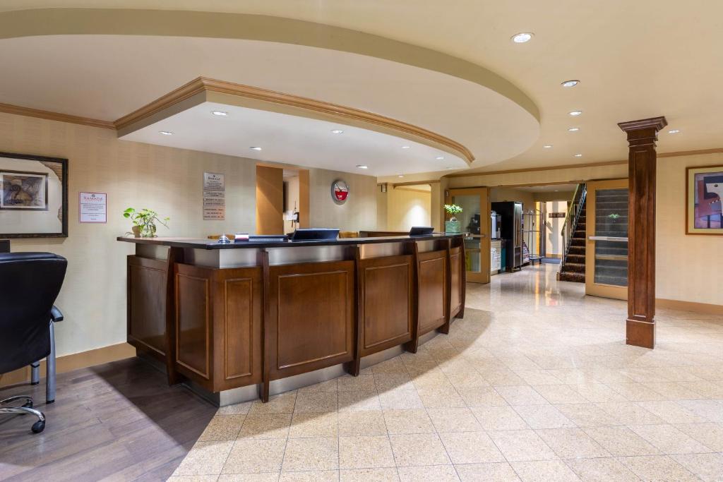 a lobby with a bar in a hospital at Ramada by Wyndham Coquitlam in Coquitlam