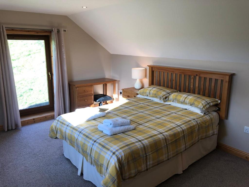 a bedroom with a bed with two pillows on it at Inveroran in Campbeltown