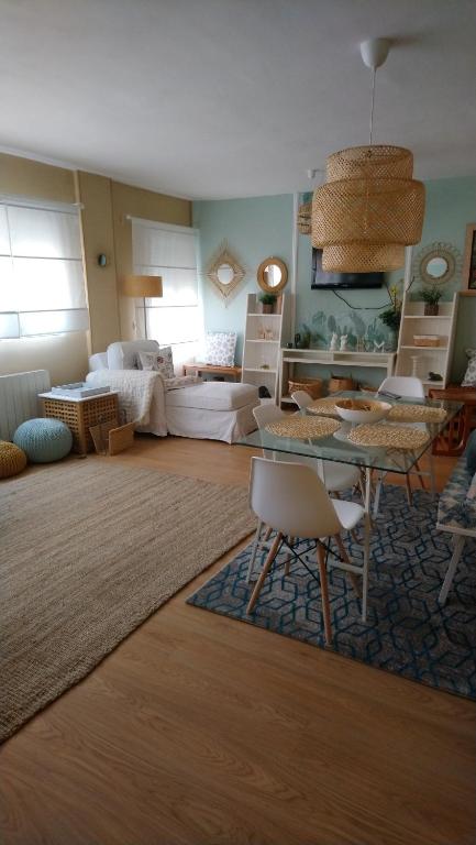 ein Wohnzimmer mit einem Tisch und einem Sofa in der Unterkunft El Escondite del Cierzo in Saragossa