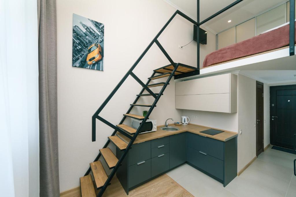 a kitchen with a loft bed and a sink at My SmartApart Hotel Today in Kyiv