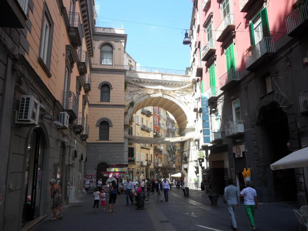 a group of people walking down a street in a city at INCANTO A CHIAIA in Naples
