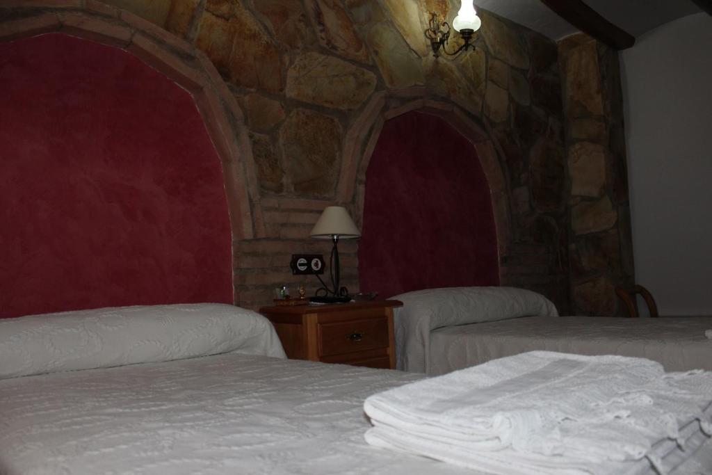 Postel nebo postele na pokoji v ubytování Casa Rural Laura