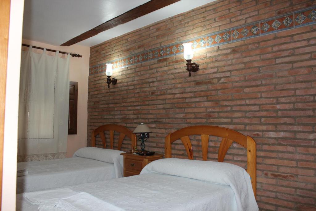 Postel nebo postele na pokoji v ubytování Casa Rural Laura