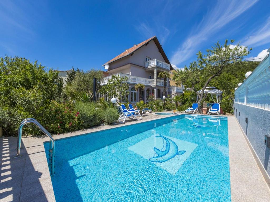 a swimming pool in front of a house at Villa Summertime in Crikvenica