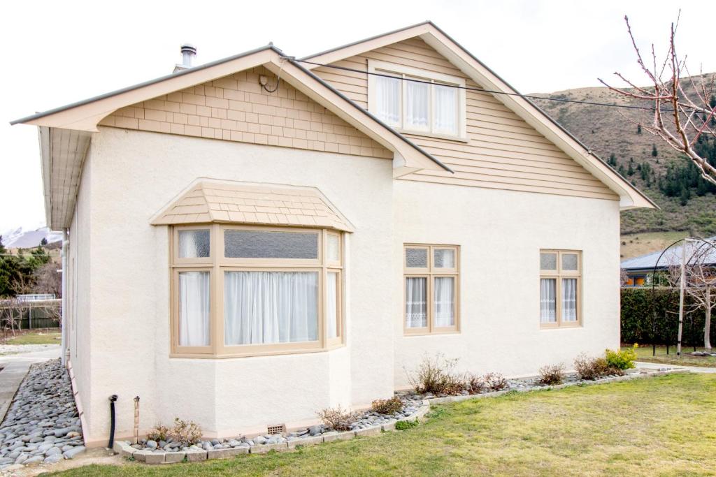 a white house with a large window at Langdale Lodge in Kurow